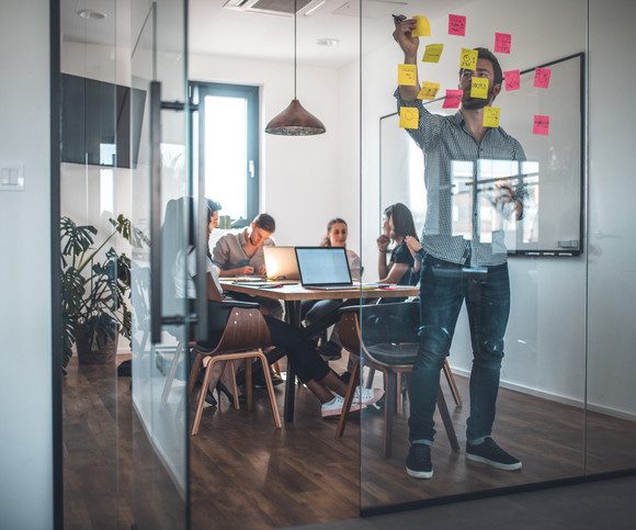 Group of people working together in office.