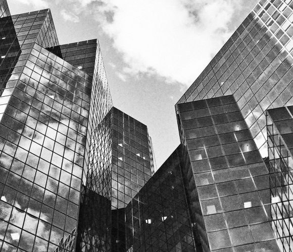Black and white photo of buildings in a city.