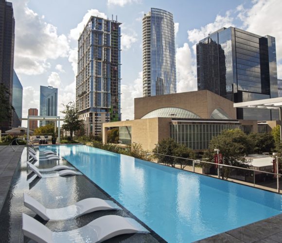 Hall Arts Residences pool deck with city view.